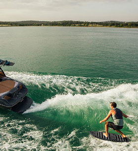 Wake surfer being towed by an ATX boat