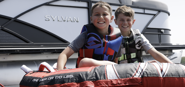 Two kids on a float for tubing