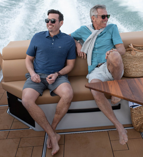 Two men in the cockpit seating of an Aviara boat