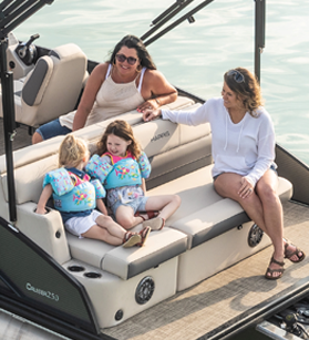 Two women and kids on a Harris pontoon