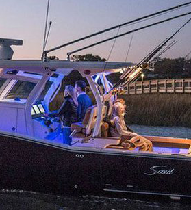 People fishing on a a Scout boat at night