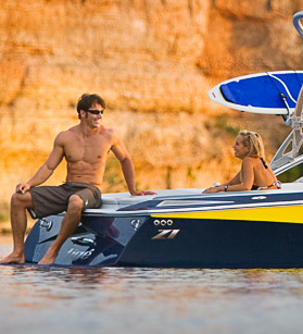 Man and woman relaxing on a Tige boat
