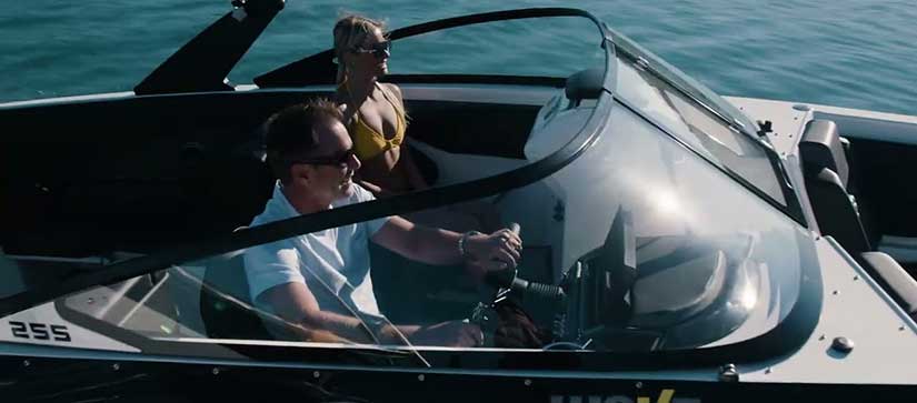Couple riding on a Scarab 255 ID boat 