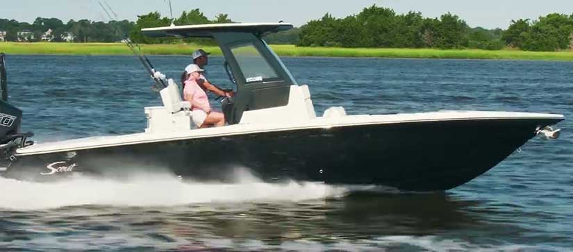Couple driving a 281 XSS Scout fishing boat