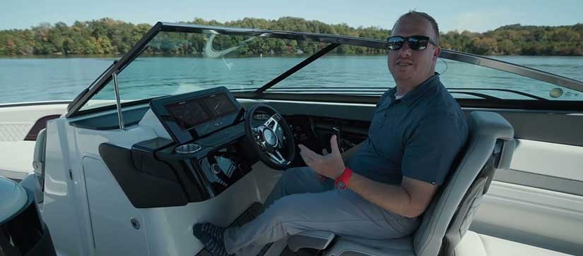 Man at the helm of a Sea Ray 260 Surf