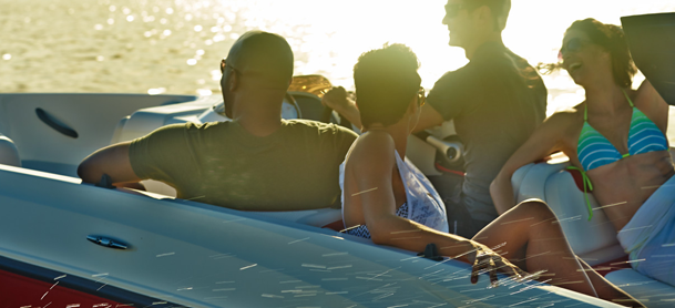 Group of people on a boat at sunset