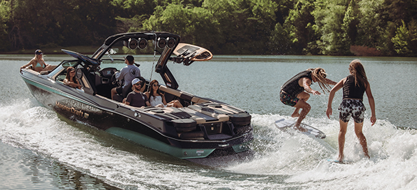 Two people wake surfing with a tow boat