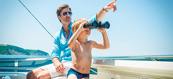 father and sun using binoculars