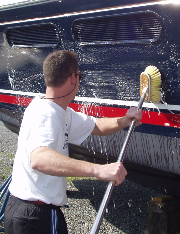 Man washing the hull of a boat