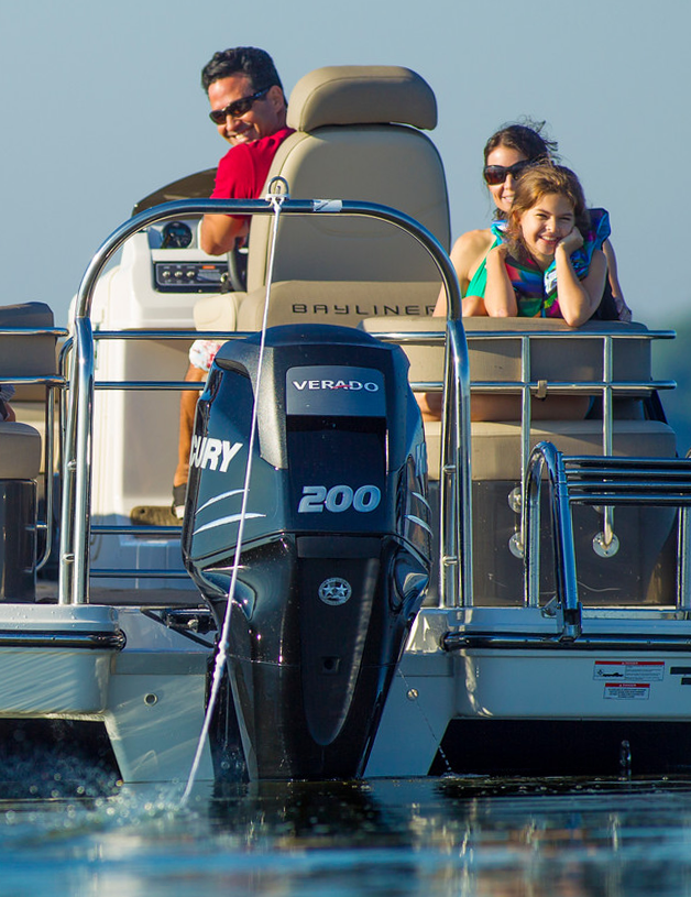 Man driving a boat with an outboard motor