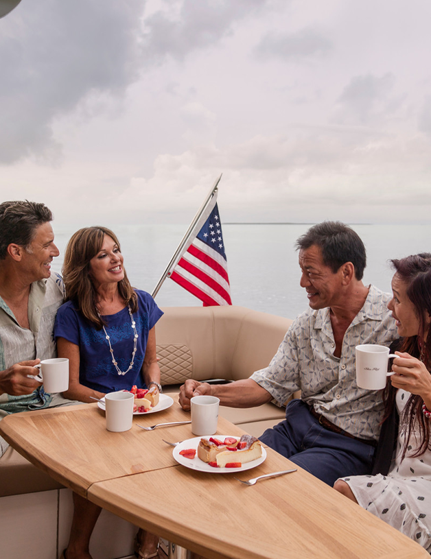 group of people around a table on a boat