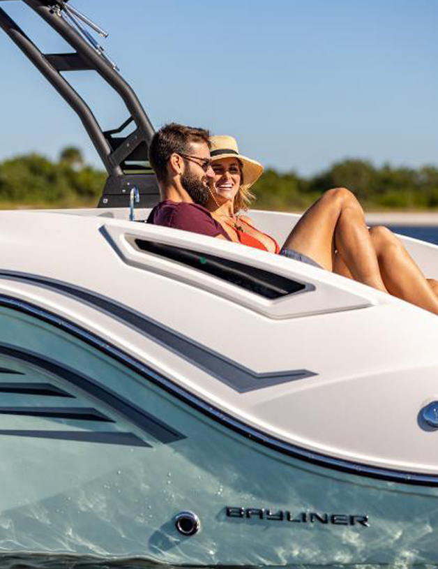 Couple sitting on the swim deck of a boat