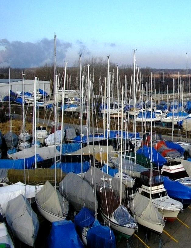 Covered boats in outdoor storage