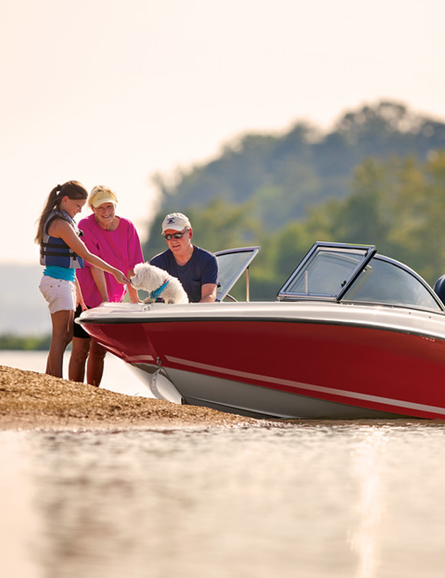 Dog on a boat with people standing around