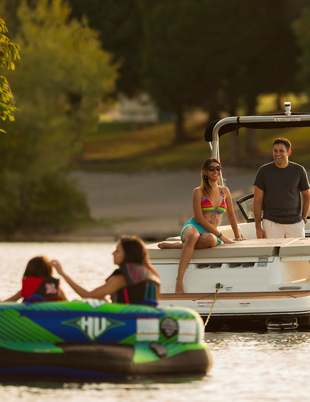 people being towed in a tube on a boat